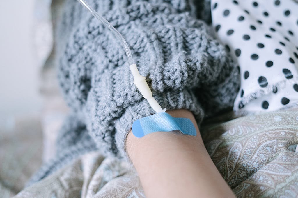 Close-up of a patient receiving intravenous therapy during cancer treatment.